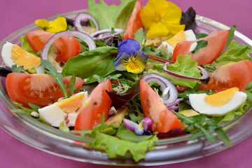fresh vegetable salad with flowers on a plate