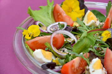  fresh salad of vegetables and flowers close-up