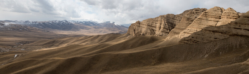 Fototapeta premium Landscape panorama of cahedral type rock mountain wall along the Kulak-Ashu pass connecting Baetov and Orto-Sirt with Tash-Rabat