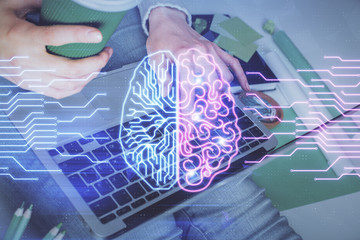 Double exposure of woman hands working on computer and brain hologram drawing. Ai concept.