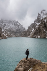 male tourist visiting Kol Suu lake in winter