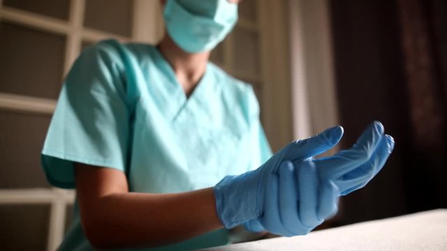 Conceptual video of a doctor putting on the gloves.