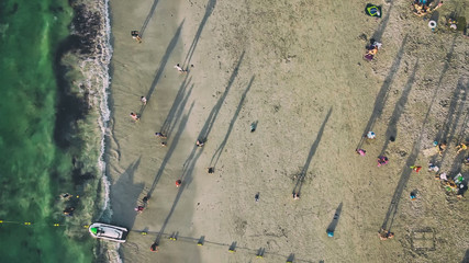 Overhead aerial view of beautiful tropical beach with tourists