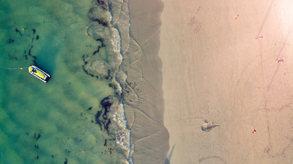 Fototapeta na wymiar Overhead aerial view of beautiful tropical beach with tourists
