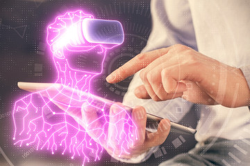 Double exposure of man's hands holding and using a digital device and AR glasses drawing. Virtual reality concept.