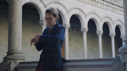 Man checking time on wristwatch outdoors. Businessman waiting for client outside