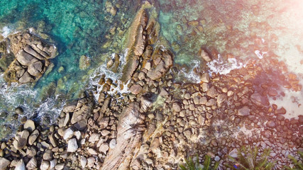 Panoramic overhead downward aerial view of beautiful tropical beach with rocks