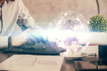 Double exposure of man's hands holding and using a phone and social network theme drawing.