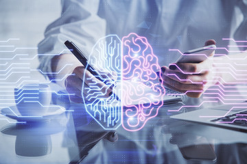 Double exposure of brain sketch hologram and woman holding and using a mobile device.