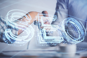 Double exposure of SEO hologram and handshake of two men. Search optimization concept.