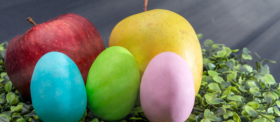 Easter eggs and fruit composition, close-up view