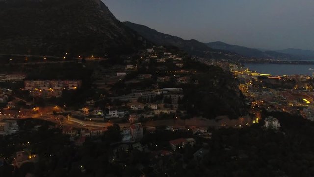 Aerial drone view of Monaco Monte Carlo bay and French Riviera Cote d'Azur sea coastline at dusk during summer