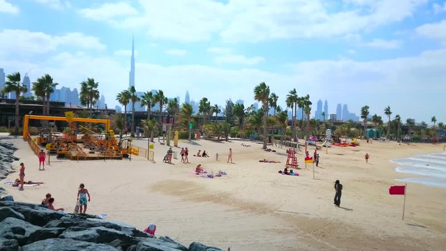 DUBAI, UAE - MARCH 4, 2020: La Mer Beach Line With Shops, Cafes, Palm Alley And Diggers Lab Kids Zone With Construction Vehicles And The Silhouette Of Burj Khalifa On Background, On March 4 In Dubai