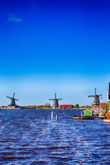 Dutch Travel Concepts. Traditional Dutch Windmills in the Village of Zaanse Schans at Daytime in the Netherlands.
