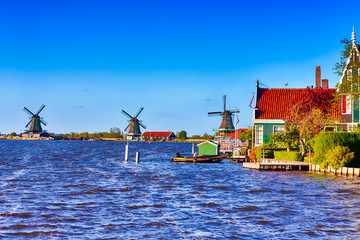 Travel Ideas. Line of Traditional Dutch Windmills in the Village of Zaanse Schans, in the Netherlands at Daytime.