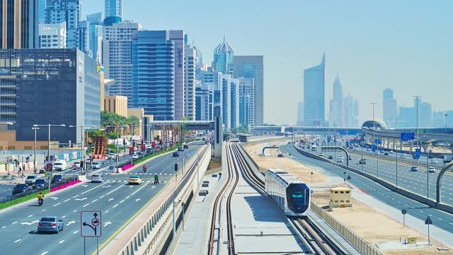 DUBAI, UAE - MARCH 7, 2020: Watch the fast traffic through the Sheikh Zayed road, Al Marsa street and modern tram, riding through its railroad in Dubai Marina, on March 7 in Dubai