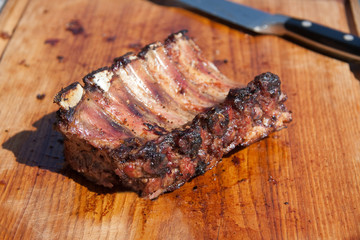 barbecued ribs on wood cutting board