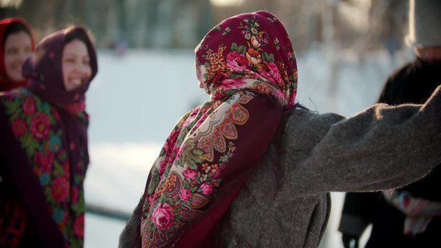 Russian folklore - a woman in a bright shawl is dancing Russian folk dance