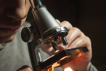 Scientist looking through his microscope