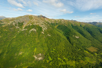 Fototapeta na wymiar aerial view of Kamchatka volcanos, green valleys, snow and ice and the wonderful view of pure nature.