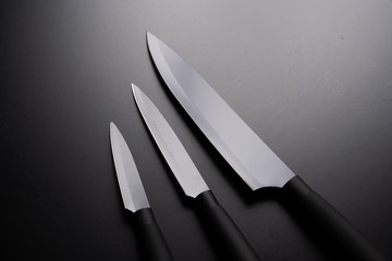 Black chef knife isolated on black background.