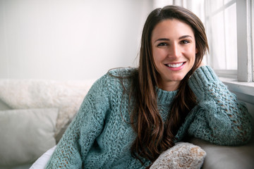 Beautiful brunette with perfect white teeth happy after dental visit, smiling in bright room, home...
