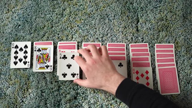 A Man finishes dealing out a game of solitaire to pass time in quarantine.