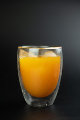 Freshly squeezed orange juice with ice cubes