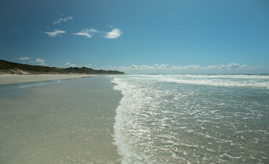 Waves on beach at Ninety Mile beach near Cape Reinga New Zealand