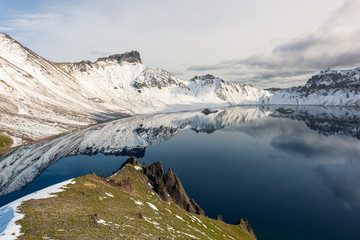 Tolbachik volcano reflection in the quiet mountain lake, Kamchatka