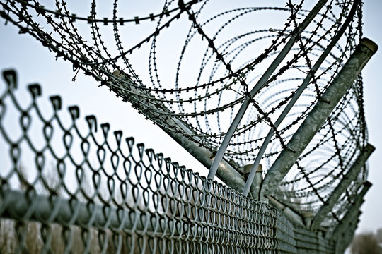 Border Fence With Barbed Wire. Closing For Quarantine. Maximum Security Detention Facility.