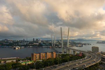 Fototapeta na wymiar Panorama of Vladivostok at sunset, Far East Russia. Golden bridge.