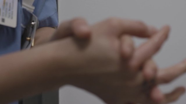 Corona virus frontline worker applying hand sanitizer in hospital