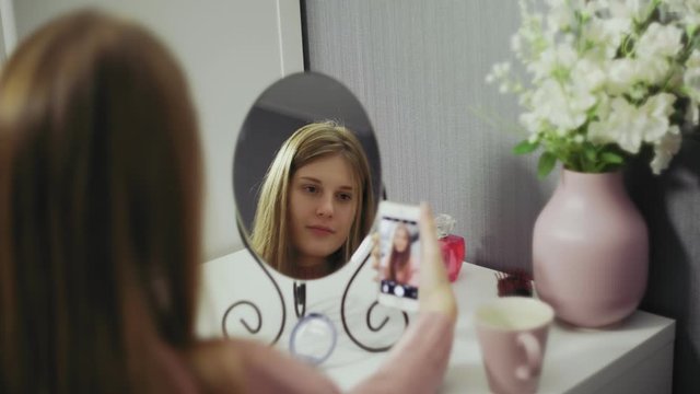 Smiling Woman Taking Mobile Selfie Photo On Phone At Mirror.