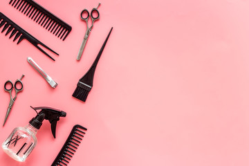 Beauty saloon accessories - combs, sciccors for hairdressing - on pink background top-down frame...