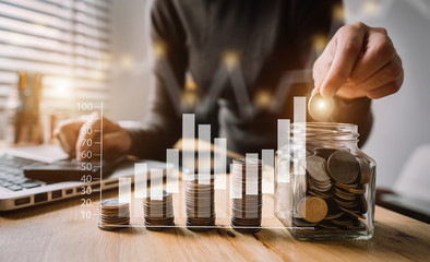 businesswoman holding coins putting in glass with using smartphone and calculator to calculate concept saving money for finance accounting
