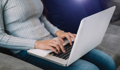 Naklejka premium Woman hands is typing on a laptop