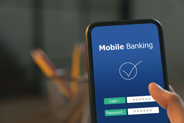 Hands press smartphone with login payment mobile banking online.