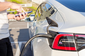 man Charges electric car