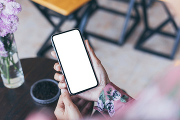 Mockup image blank white screen cell phone.woman hand holding texting using mobile on desk at coffee shop.background empty space for advertise text.people contact marketing business,technology