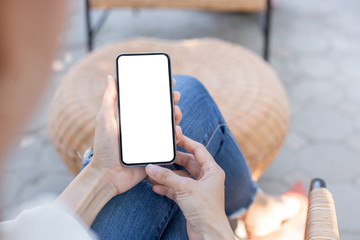 Mockup image blank white screen cell phone.woman hand holding texting using mobile on desk at coffee shop.background empty space for advertise text.people contact marketing business,technology
