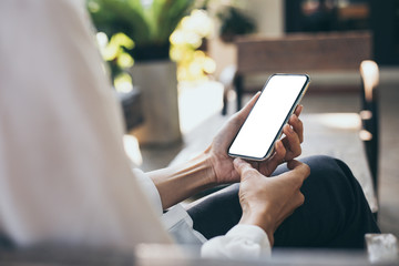 Mockup image blank white screen cell phone.woman hand holding texting using mobile on desk at coffee shop.background empty space for advertise text.people contact marketing business,technology