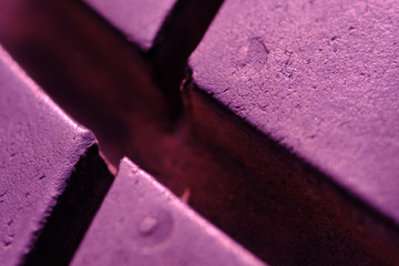 Abstract macro photography – close up tire texture pattern with violet light