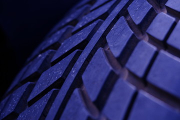 Abstract macro photography – close up dirty tire texture pattern with purple light