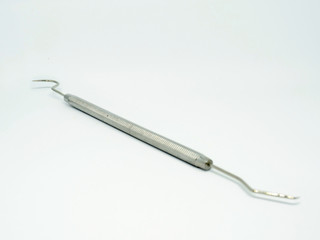 Dentist scaler angled on white background.