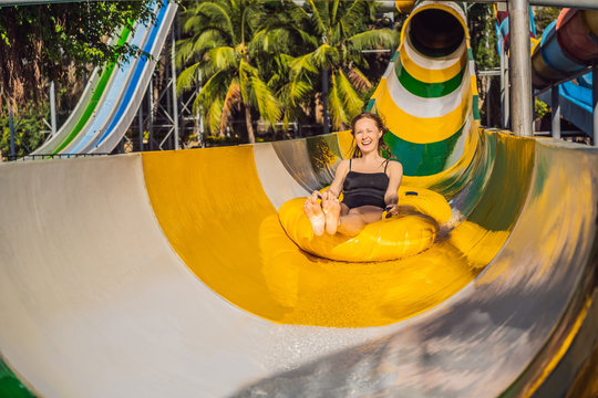 Happy Woman Going Down A Water Slide