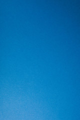 Blue paper background, copy space, vertical.
