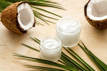 Obraz na płótnie Canvas Face care. Coconut cream in glass jar on beige background