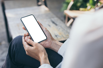 Mockup image blank white screen cell phone.woman hand holding texting using mobile on desk at coffee shop.background empty space for advertise text.people contact marketing business,technology
