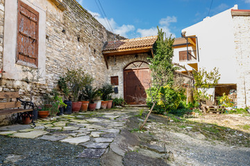 winding streets and old houses with flowers in pots in the traditional village of Lefkara on the island of Cyprus